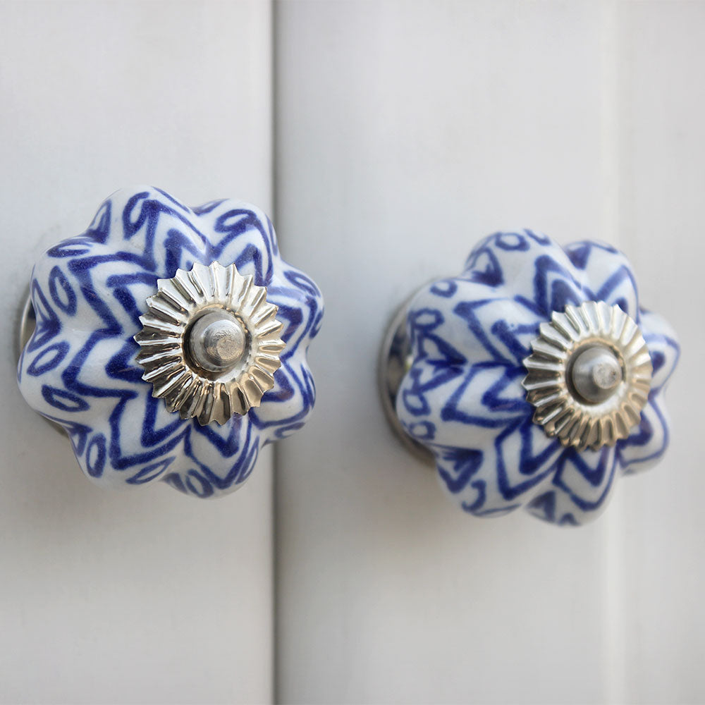 flower shaped white ceramic knobs with silver fittings and blue handpainted pattern