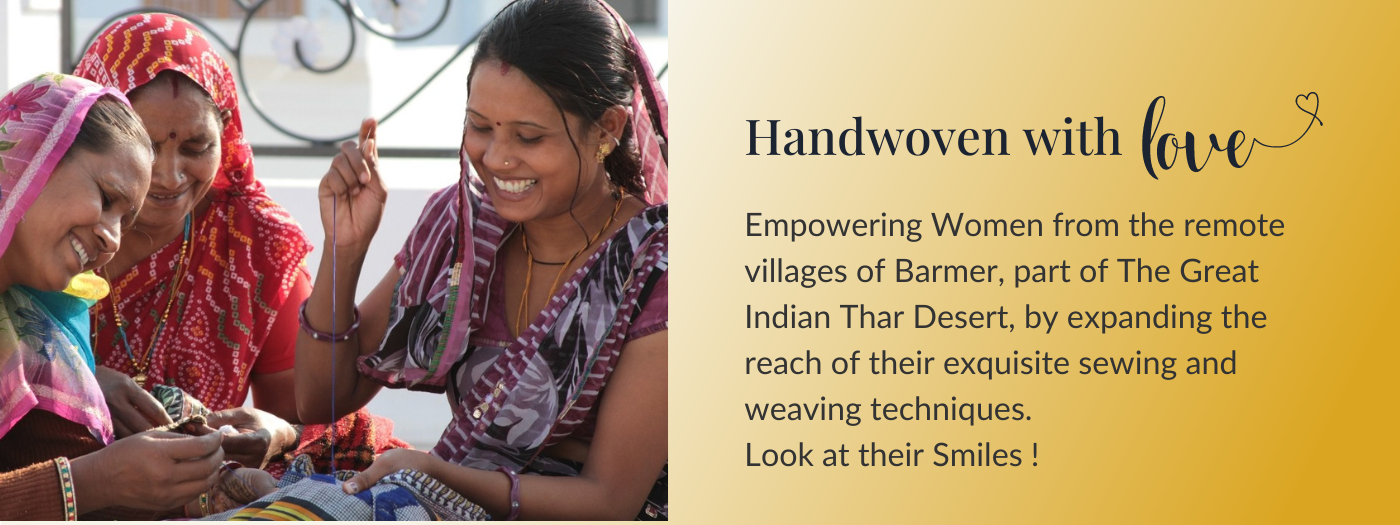 three women from Barmer Rajasthan in India, sewing and weaving fabric by hand smiling 